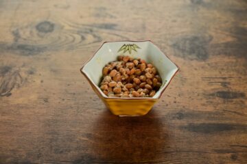 Natto — fermented soybeans served in a traditional hexagonal ceramic bowl on a wooden surface