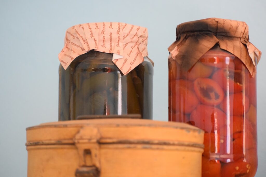 Cloth-covered fermentation jars, representing the slow room-temperature fermentation process used in traditional kefir making