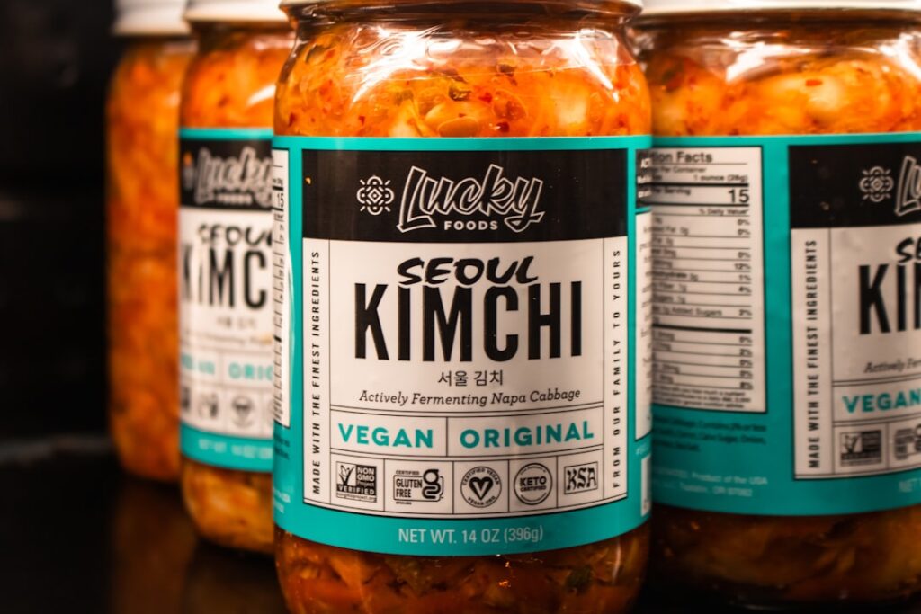 Jars of Seoul Kimchi labelled actively fermenting vegan napa cabbage on a store shelf